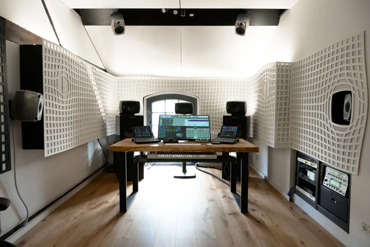 Mixing position at Immersive Lab with control surfaces, monitor controller and the acoustic treatment by kost.acoustics.