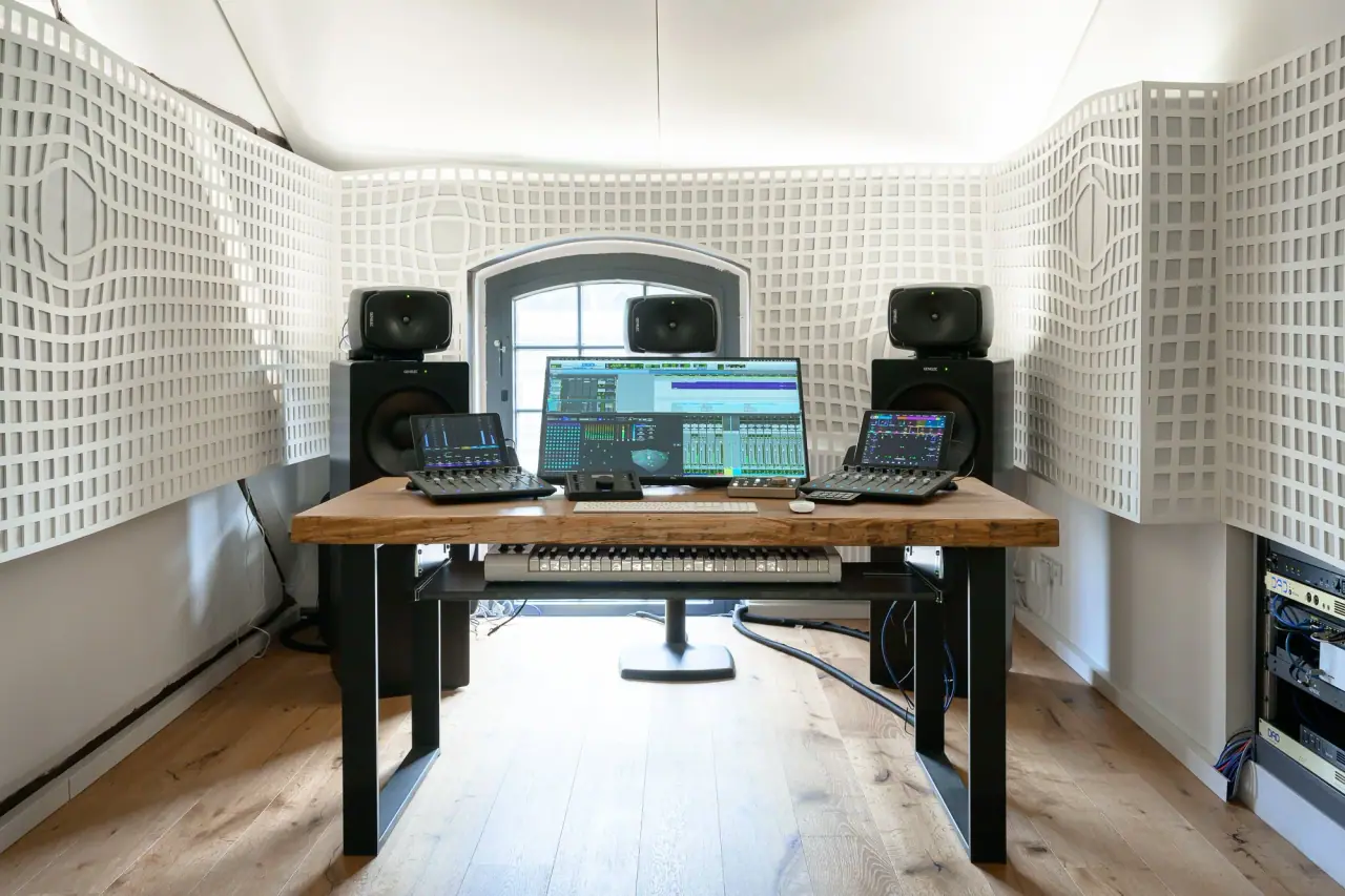 The Immersive Lab control room seen from the rear: mixing desk, Genelec monitors and diffusor panels on both side walls.